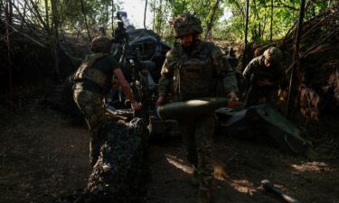 Ukrainian servicemen fire a M777 howitzer toward Russian troops near a front line in the Donetsk region