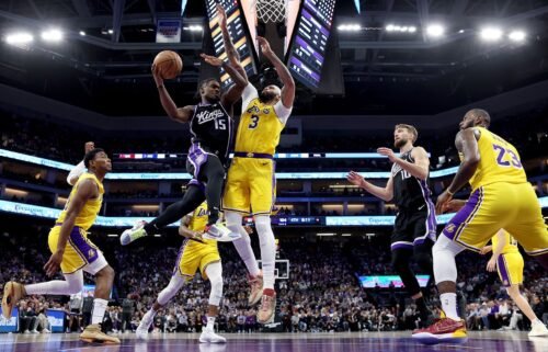 Davion Mitchell #15 of the Sacramento Kings goes up for a shot on Anthony Davis #3 of the Los Angeles Lakers. Warner Bros. Discovery is in danger of losing NBA broadcast rights to NBCUniversal.