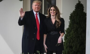 Then-President Donald Trump stands next to Hope Hicks in 2018