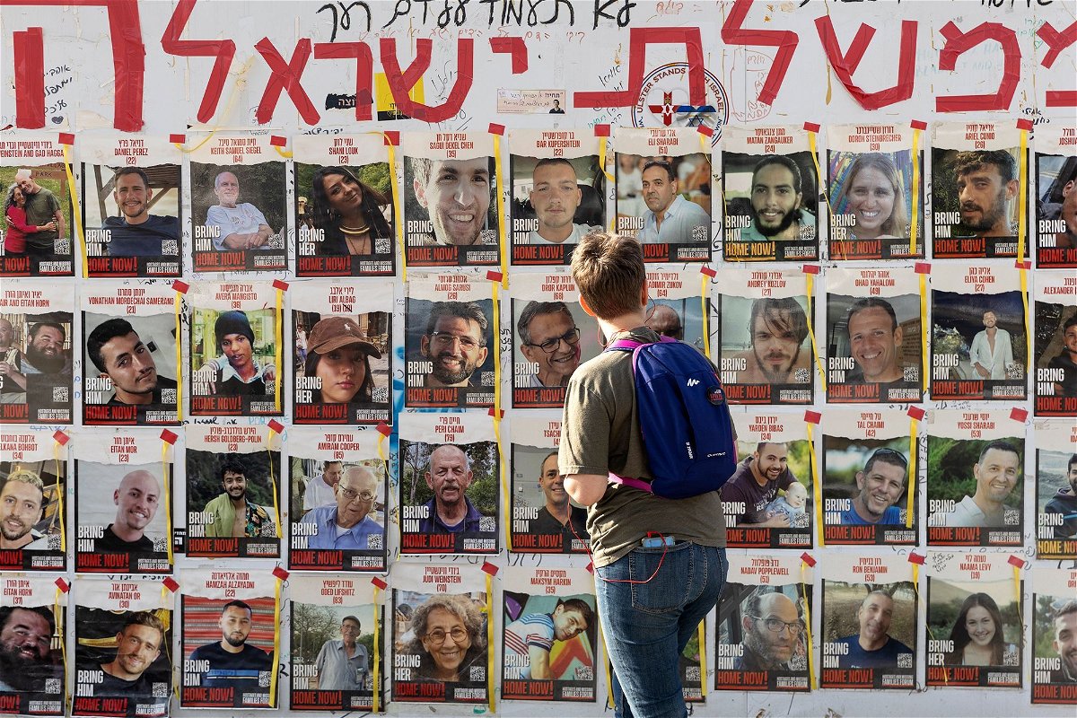 A women looks at photos of hostages held by Hamas in Gaza on May 1