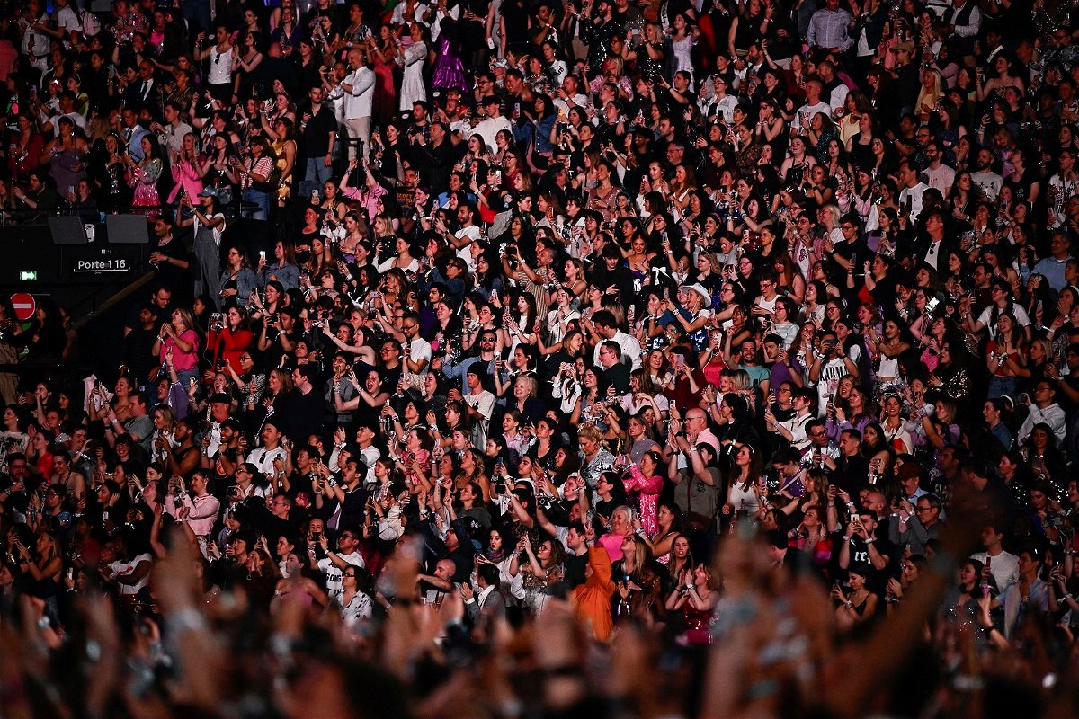 <i>Julien De Rosa/AFP/Getty Images via CNN Newsource</i><br/>Fans watch Swift at her concert in Paris last week.