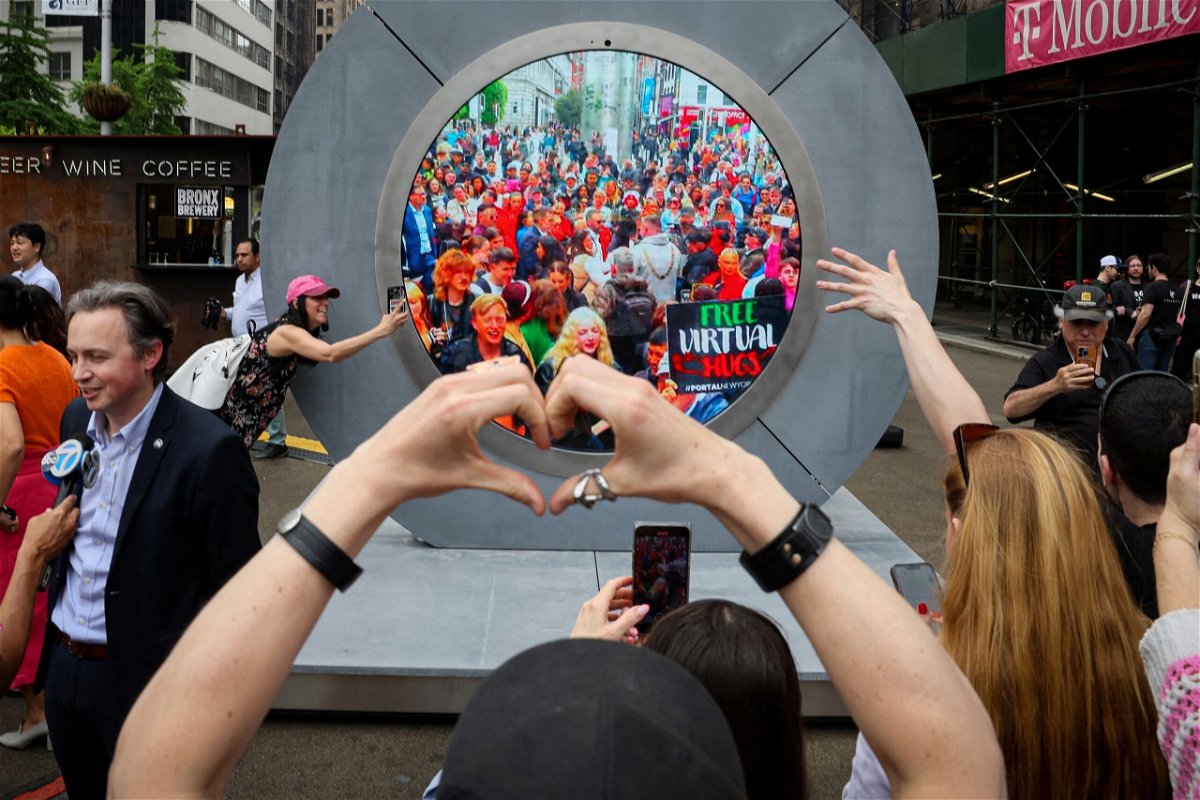 <i>Brendan McDermid/Reuters via CNN Newsource</i><br/>New Yorkers greet people in Dublin during the reveal of New York City's Portal on May 8.