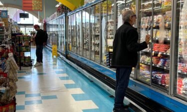 A customer shops for food at a grocery store on March 12 in San Rafael