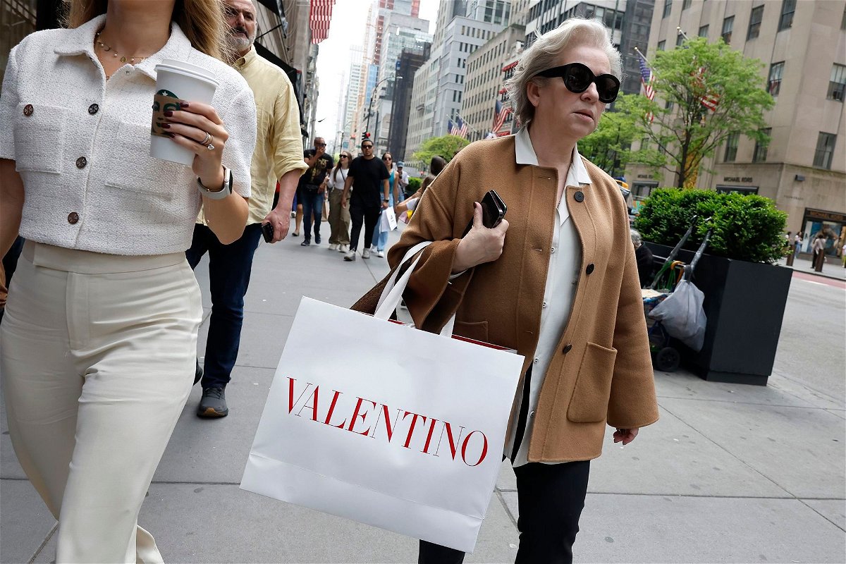 <i>Michael M. Santiago/Getty Images via CNN Newsource</i><br/>People walk along Fifth Avenue with shopping bags on May 8 in New York City. Inflation cooled back down in April