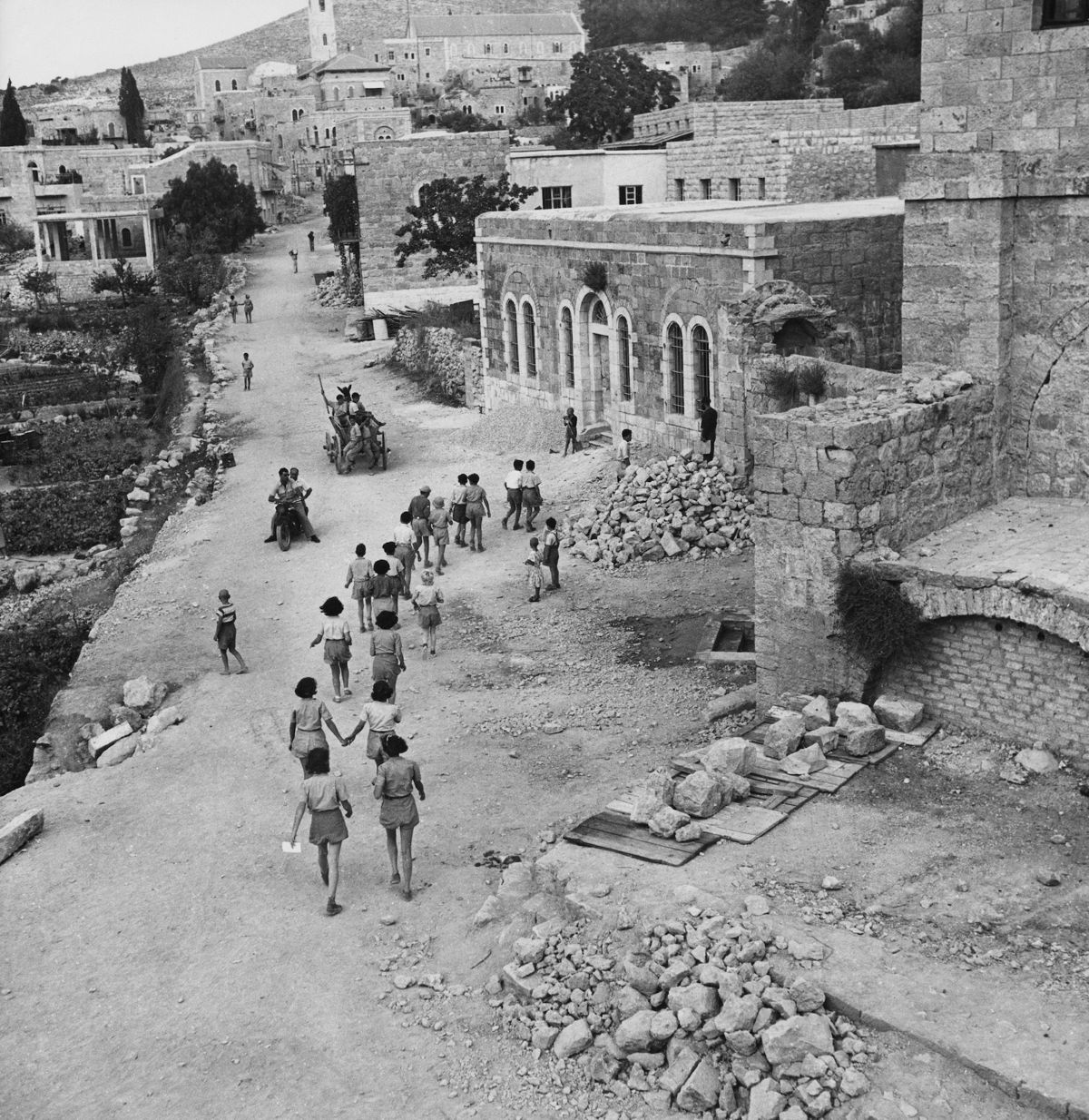 <i>George Pickow/Three Lions/Hulton Archive/Getty Images via CNN Newsource</i><br/>Israeli students on their way to school in Ein Karem circa 1955. The buildings on the right show damage dating from the 1948 Arab-Israeli War.