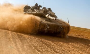 An Israeli army battle tank moves near the border with the Gaza Strip at a location in southern Israel on May 13