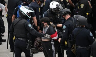 Police detain a pro-Palestinian demonstrator as they clear an encampment after protesters surrounded the Physical Sciences Lecture Hall at the University of California