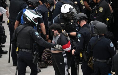 Police detain a pro-Palestinian demonstrator as they clear an encampment after protesters surrounded the Physical Sciences Lecture Hall at the University of California