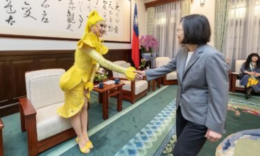 Taiwanese drag queen Nymphia Wind shakes hands with Taiwan's outgoing leader Tsai Ing-wen.