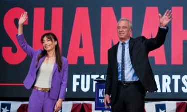 Robert F. Kennedy Jr. and Nicole Shanahan wave onstage during a campaign event in Oakland