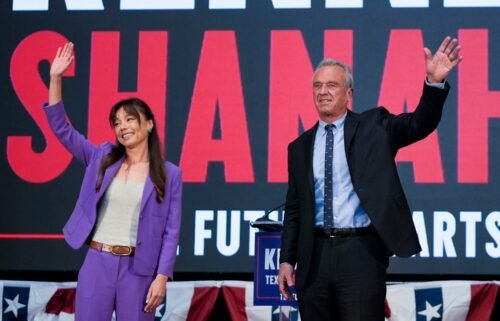 Robert F. Kennedy Jr. and Nicole Shanahan wave onstage during a campaign event in Oakland