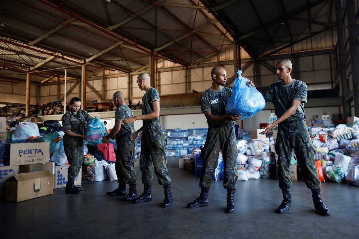 <i>Adriano Machado/Reuters via CNN Newsource</i><br/>Brazilian Air Force Soldiers prepare donations for flood victims at the Brasilia Air Force Base.