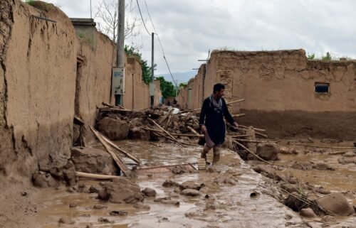 An Afghan man walks near his damaged home after heavy flooding in Baghlan province Saturday.