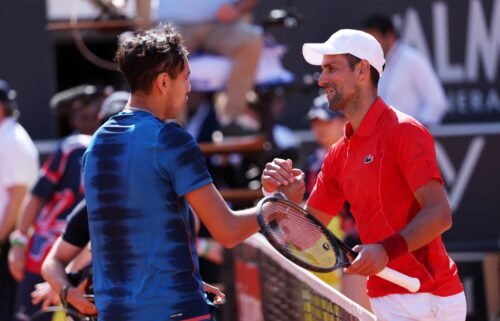 Novak Djokovic (left) and Alejandro Tabilo shake hands at the net.