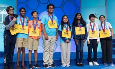 The final eight competitors of the Scripps National Spelling Bee pose for a group photograph after the conclusion of the semifinals