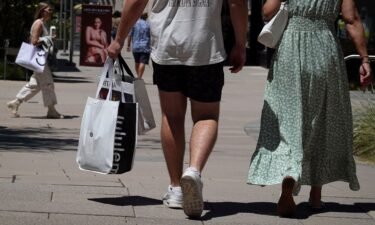 Shoppers carry shopping bags while walking through The Village at Corte Madera on May 30 in Corte Madera