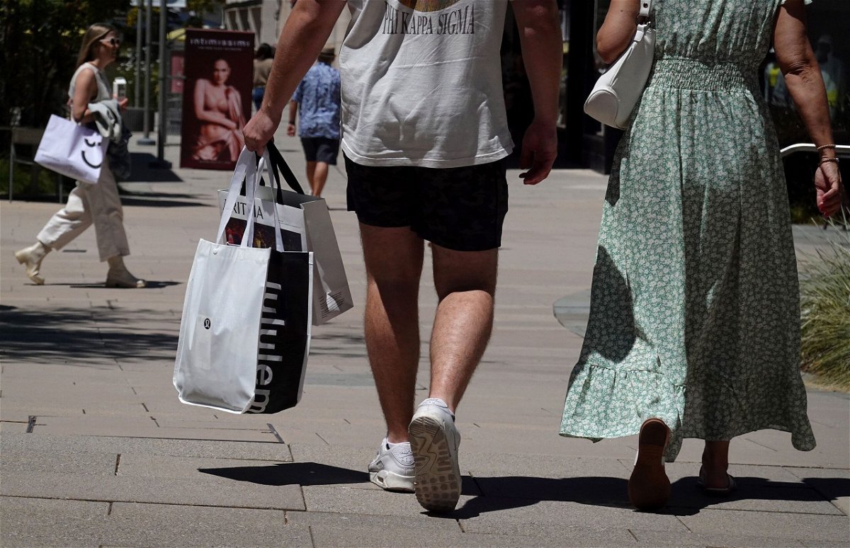 <i>Justin Sullivan/Getty Images via CNN Newsource</i><br/>Shoppers carry shopping bags while walking through The Village at Corte Madera on May 30 in Corte Madera