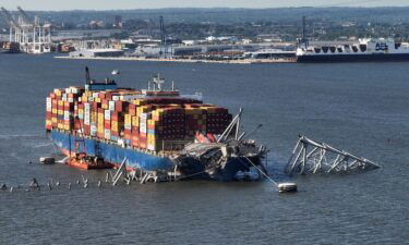 This aerial view shows debris from the destroyed Francis Scott Key Bridge being detached from the container ship Dali.