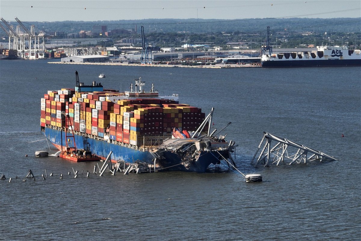 <i>Chip Somodevilla/Getty Images via CNN Newsource</i><br/>This aerial view shows debris from the destroyed Francis Scott Key Bridge being detached from the container ship Dali.