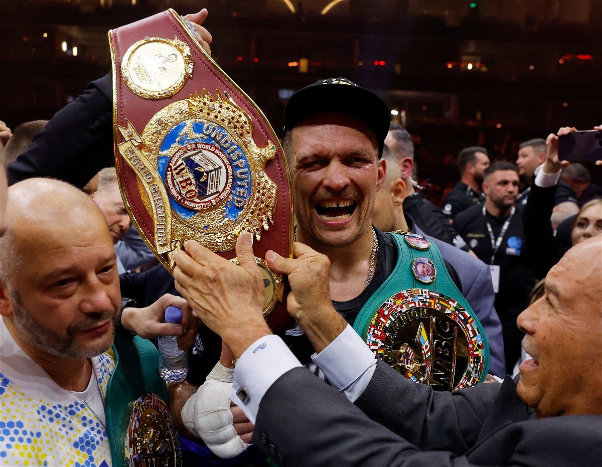 <i>Andrew CouldridgeAction Images/Reuters via CNN Newsource</i><br/>Oleksandr Usyk celebrates with the belts after becoming the undisputed heavyweight world champion.