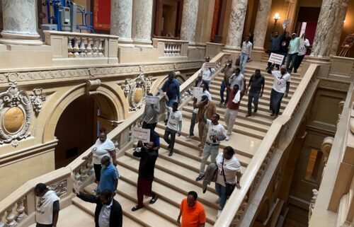 Protesters descend a staircase in the Minnesota State Capitol building in St. Paul