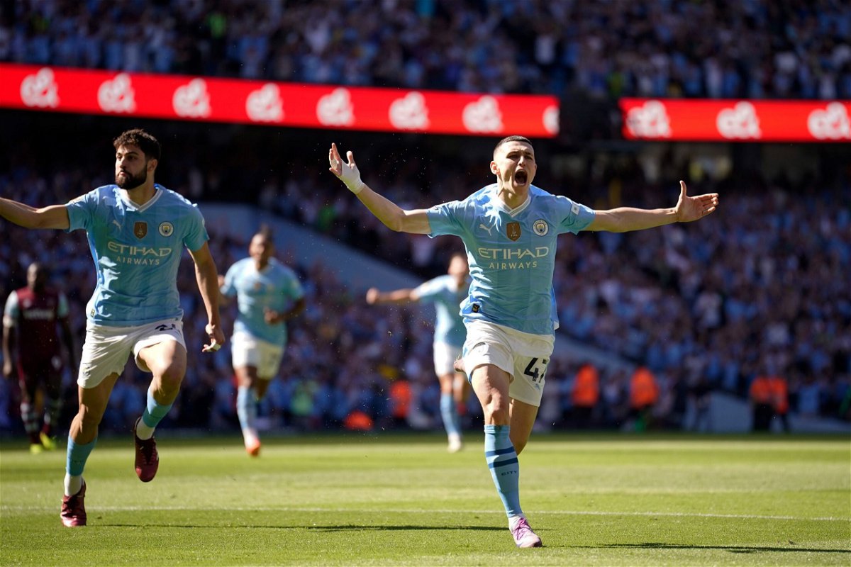 <i>Dave Thompson/AP via CNN Newsource</i><br/>Phil Foden celebrates after scoring the opening goal for Manchester City.
