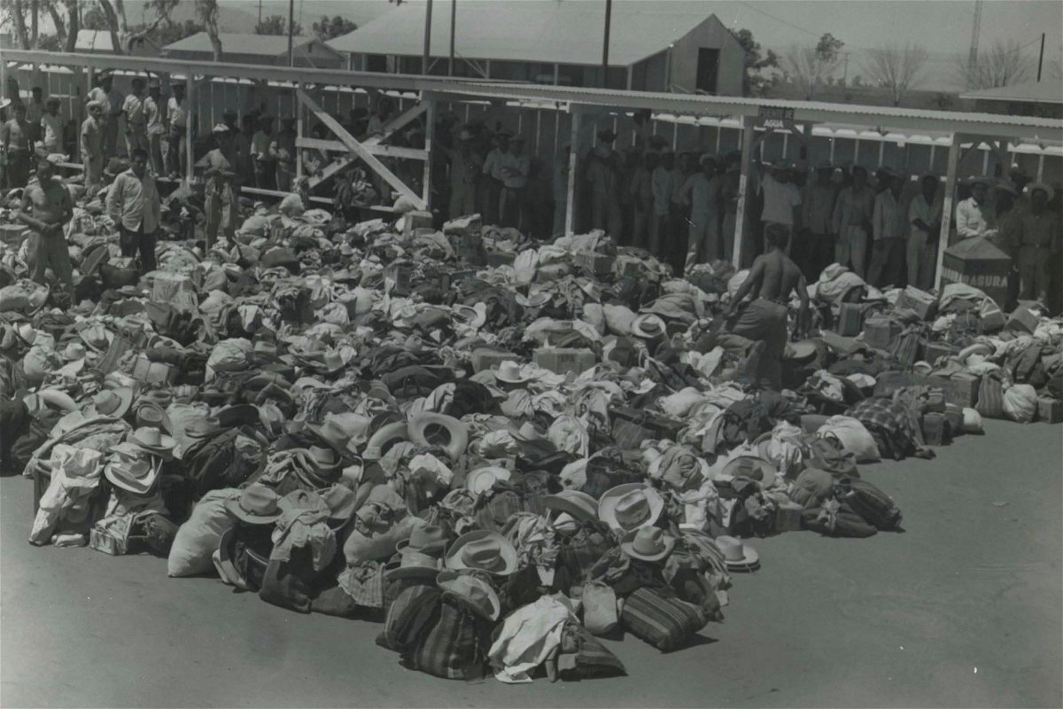 <i>USCIS History Office and Library/Department of Homeland Security via CNN Newsource</i><br/>Aspiring braceros line up to undergo physical examinations by the US Public Health Service in South Texas in the 1950s. Their hats