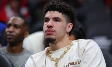 LaMelo Ball looks on from the bench during the first quarter of the Charlotte Hornets' game against the Atlanta Hawks at State Farm Arena on March 23.