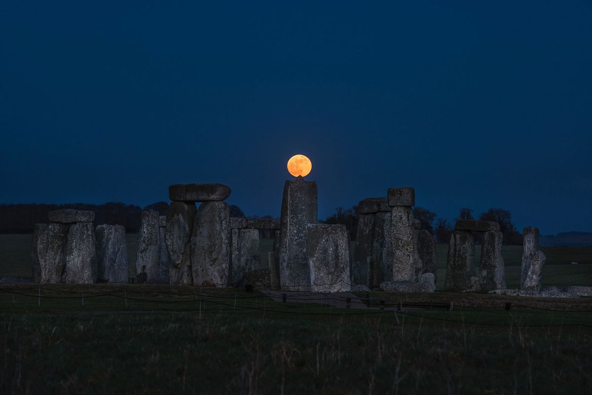 <i>Andre Pattenden/English Heritage via CNN Newsource</i><br/>The moon is seen above the megaliths that make up Stonehenge