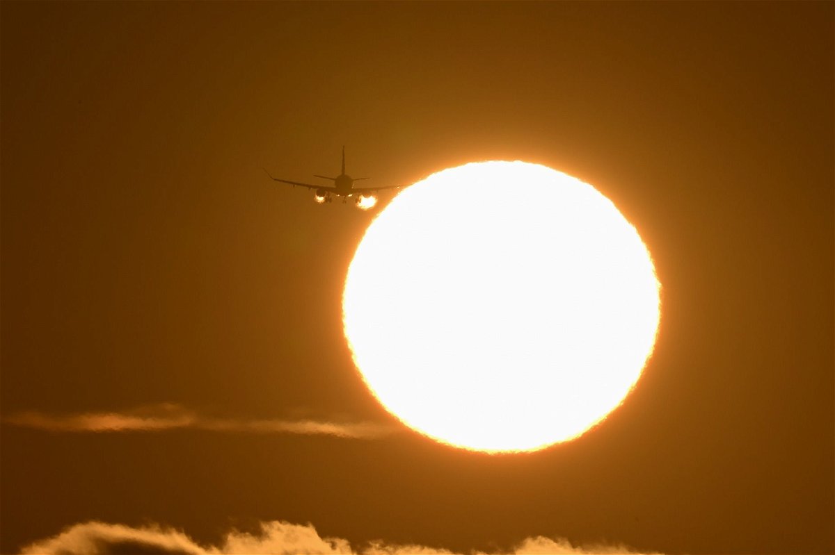 <i>Tayfun Coskun/Anadolu Agency/Getty Images via CNN Newsource</i><br/>A plane arrives at San Francisco International Airport during sunset on May 15. Much of the country is forecast to have higher-than-average temperatures this summer. That could affect flights depending on how hot it gets.
