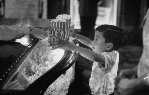 A child buys popcorn at a movie concession stand in Texas in June 1949.