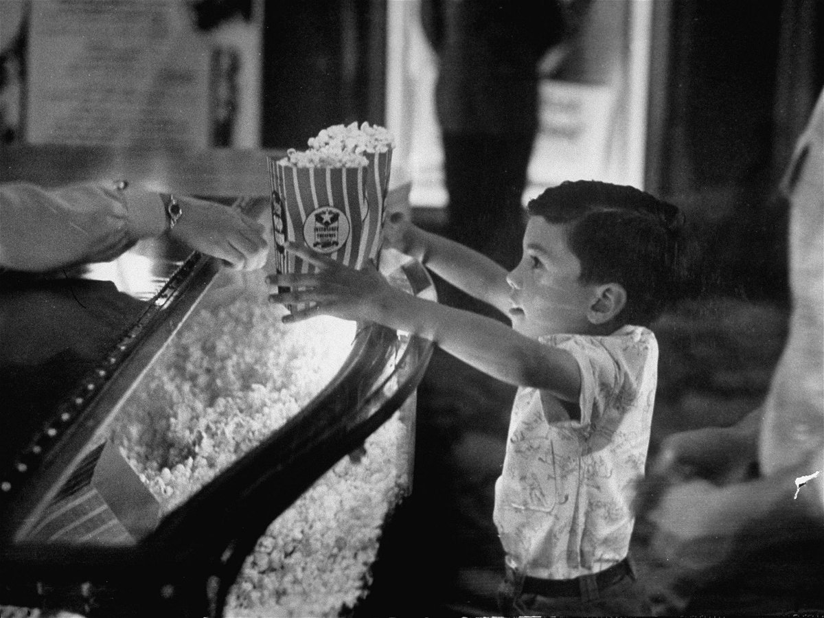 <i>Peter Stackpole/The LIFE Picture Collection/Shutterstock via CNN Newsource</i><br/>A child buys popcorn at a movie concession stand in Texas in June 1949.