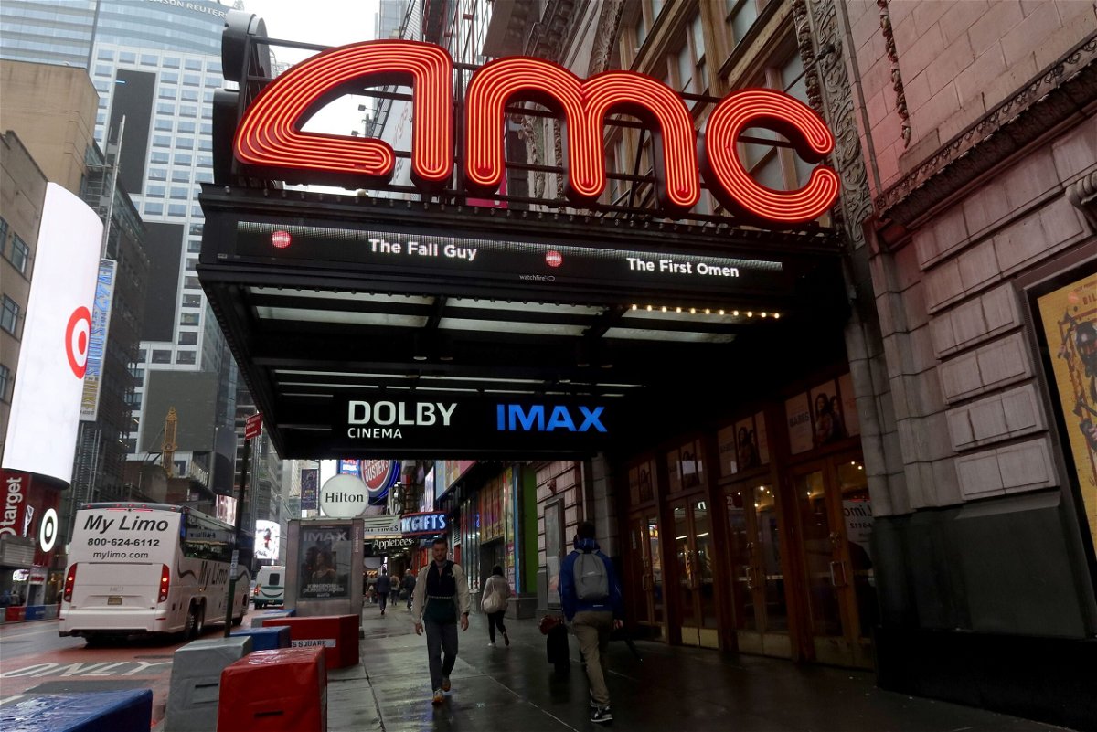 <i>Gary Hershorn/Getty Images via CNN Newsource</i><br/>People walk past an AMC movie theater on 42nd Street in Times Square on May 16