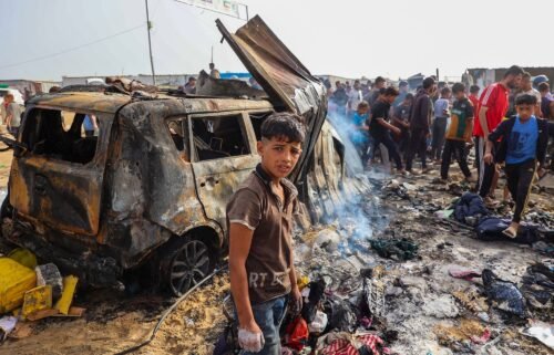 Palestinians gather at the site of an Israeli strike on a camp housing internally displaced people in Rafah