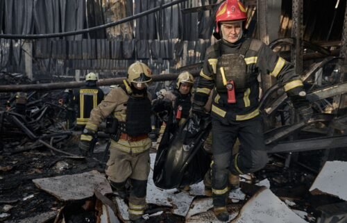 Emergency workers carry out the body of a victim of a Russian strike that hit a large store in Kharkiv.
