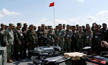 Commander-in-Chief of the Royal Cambodia Armed Forces Vong Pisen (C-L) and Chinese People's Liberation Army (PLA) Southern Theater Command's Gao Xiucheng (center R) attend a demonstration of a machine gun equipped robot battle "dog" (C) during the Cambodian-Chinese Dragon Gold-2024 drill at a military police base in Kampong Chhnang province on May 16.