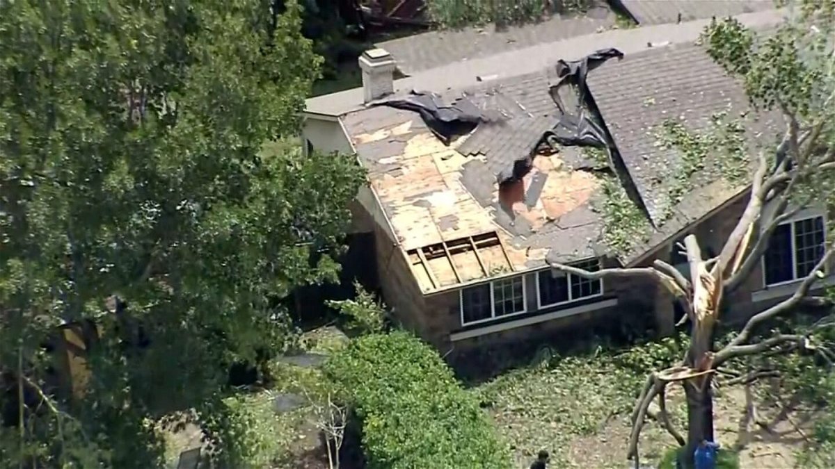 <i>KTVT via CNN Newsource</i><br/>Storms shredded a roof in the Dallas-Fort Worth area on May 29.