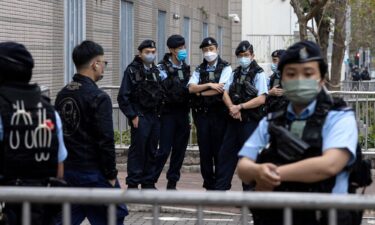 Police stand guard outside the West Kowloon Magistrates' Courts during the hearing of Hong Kong's 47 pro-democracy activists on February 6