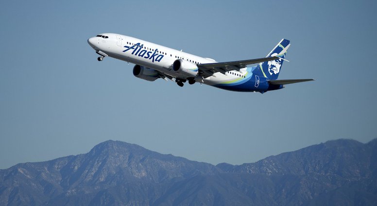 An Alaska Airlines plane takes off from Los Angeles International Airport. The airline has reached a tentative labor deal with its flight attendants union, the two sides announced late Friday.