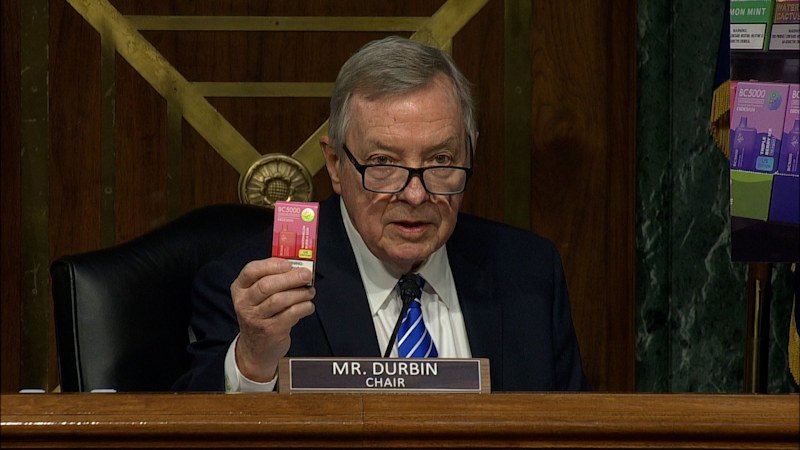 At a hearing, Sen. Dick Durbin holds up what he says is an unauthorized flavored e-cigarette product that his staff bought at a vape shop just a mile from FDA headquarters.
