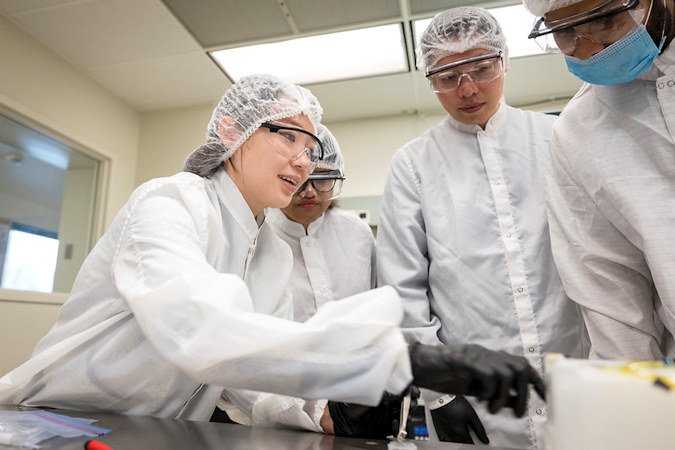 Sieun Chae and her OSU students investigate the samples of oxide thin films deposited by pulsed laser deposition facilities. The samples will be used to fabricate memory devices. Pictured are Chae, left, and doctoral student Dipannita Ghosh. 