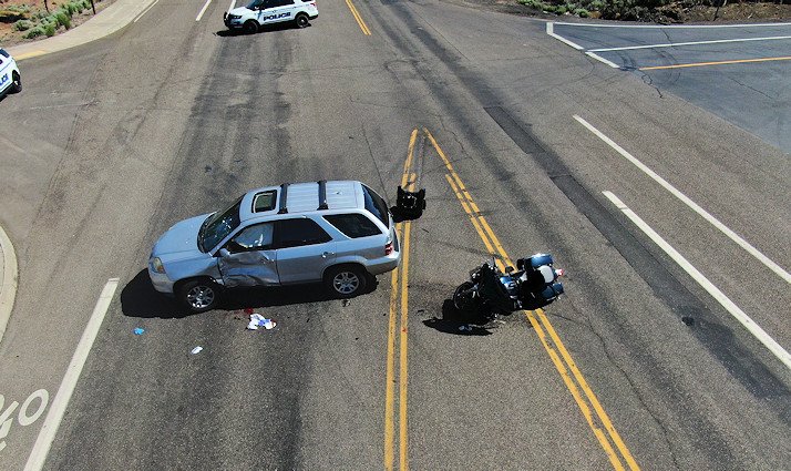 Police say SUV driver was making illegal U-turn when he collided with a motorcycle; both riders taken to hospital
