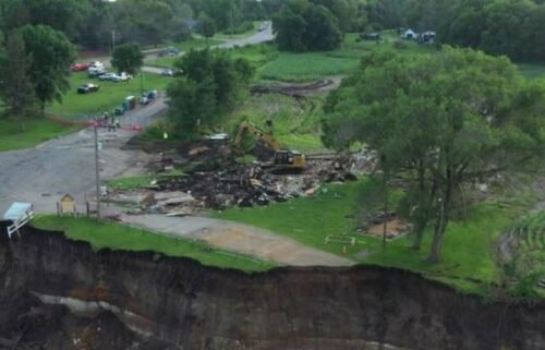 Blue Earth County officials on Friday bought and demolished the iconic Rapidan Dam Store to prevent it from falling into the Blue Earth River.