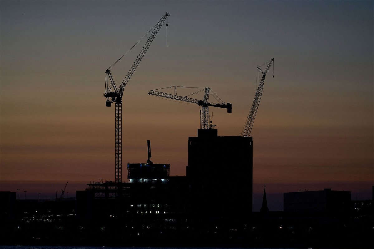 <i>Geoff Robins/AFP/Getty Images via CNN Newsource</i><br/>Construction cranes are silhouetted against the sky in Detroit on September 13
