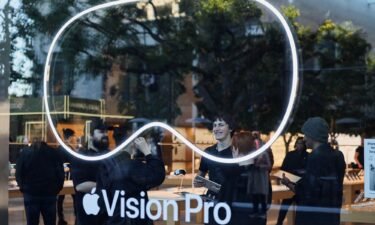 Employees stand in an Apple store on the day Apple's Vision Pro headset goes on sale in Los Angeles