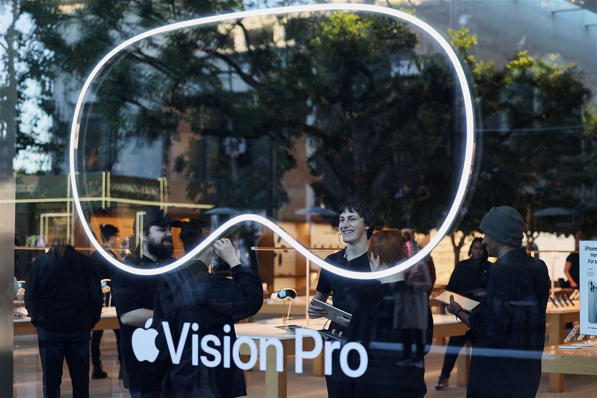 <i>Mike Blake/Reuters via CNN Newsource</i><br/>Employees stand in an Apple store on the day Apple's Vision Pro headset goes on sale in Los Angeles