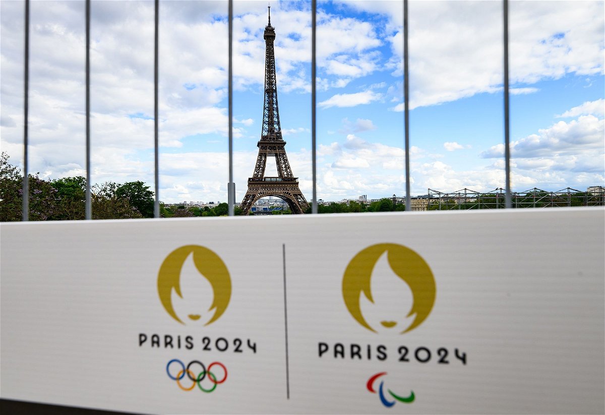 <i>Robert Michael/picture alliance/dpa/Getty Images via CNN Newsource</i><br/>The Olympic rings and the Paralympic Games logo can be seen on a sign on a construction fence in front of the Eiffel Tower. The Olympic Games and Paralympics take place in France this summer.