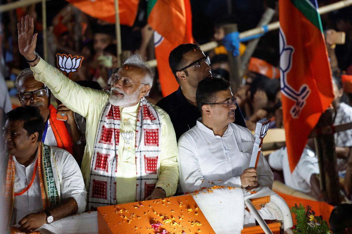 <i>Sahiba Chawdhary/Reuters via CNN Newsource</i><br/>India's Prime Minister Narendra Modi waves to supporters during a roadshow as part of an election campaign