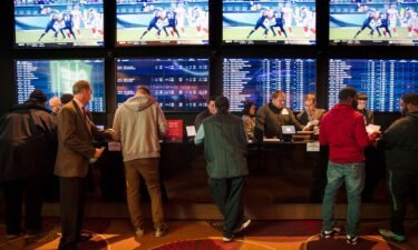 Gamblers place bets in the temporary sports betting area at the SugarHouse Casino in Philadelphia.