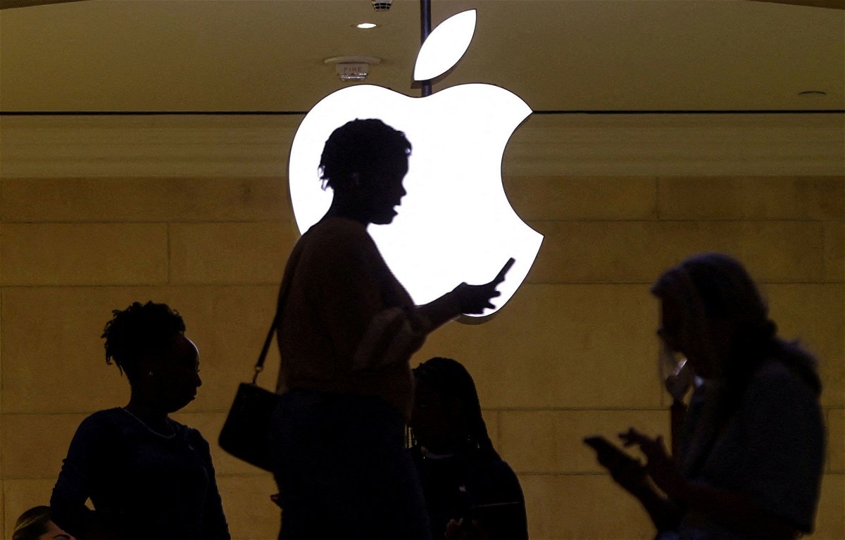 <i>Mike Segar/Reuters via CNN Newsource</i><br/>A woman uses an iPhone at the Apple store at Grand Central Terminal in New York City. Apple is widely expected to announce a partnership with ChatGPT maker OpenAI.
